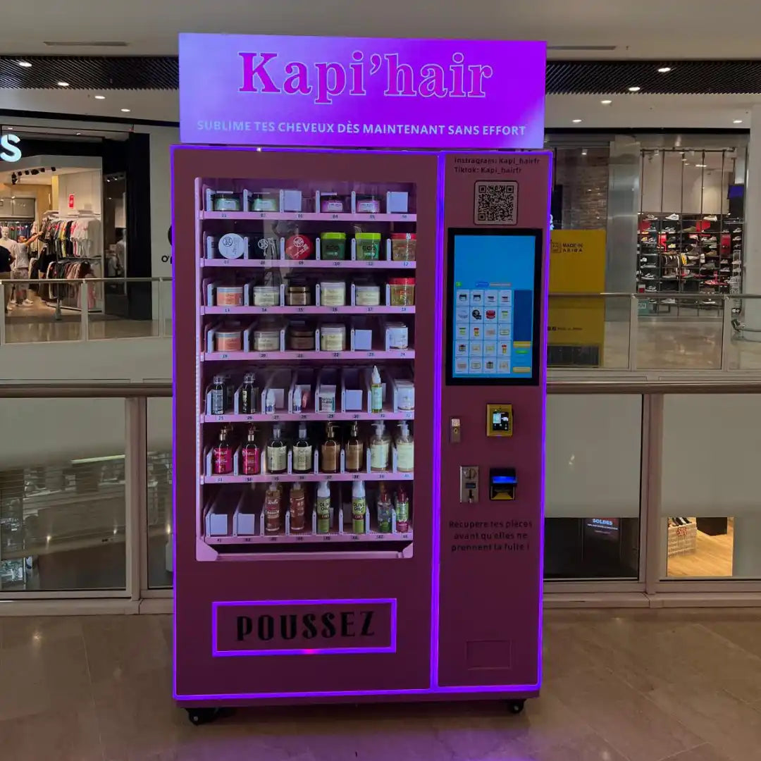 Une machine distributrice violette proposant des produits capillaires.